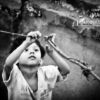 Kid Ties a Knot, by Swaroop Singha Roy - Candid Photography, Photojournalism, Child Photography, Street Photography, Award Winning Photo