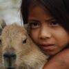 Peruvian Girl and Friend, by Claudio Bacinello - Photojournalism, Photography Awards, Portrait Photography, Documentary Photography, Capybara