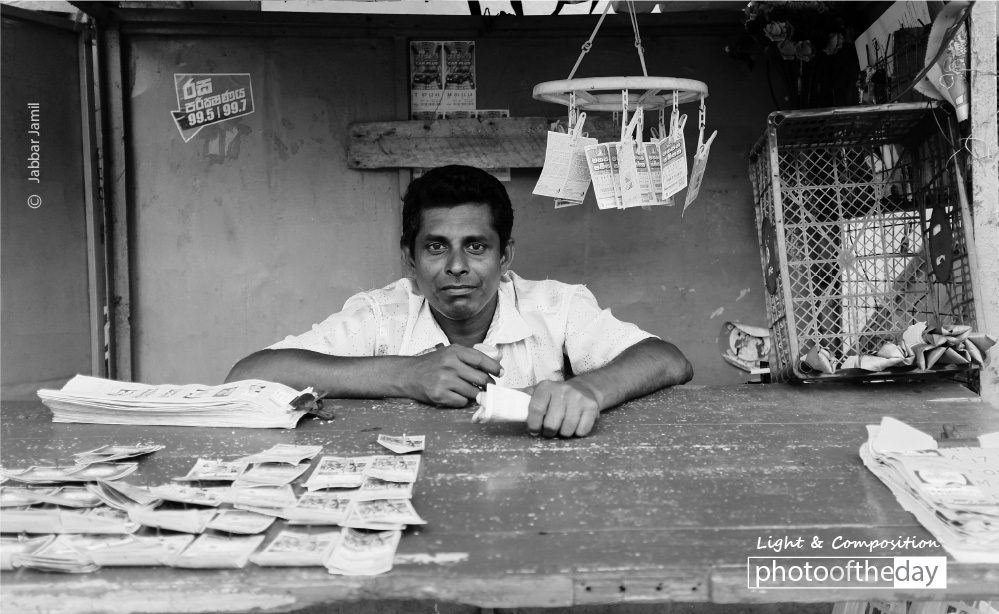 The Lottery Ticket Seller, by Jabbar Jamil - Street Photography, Photojournalism, Portrait Photography, Photo of the Day, Photography Awards