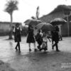 School Kids in the Rain by Lavi Dhurve - Photojournalism, Black and White Photography, Documentary Photography, Award Winning Photography, Photography Education