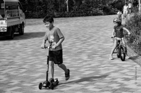 Playing Push Scooter by Siew Bee Lim - Street Photography, Photo of the Day, Photography Awards, Art Photography, Online Photography Courses