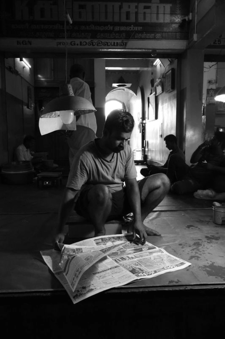 Photojournalism, Documentary Photography, Black and White Photography, Photography Awards, Light & Composition University - The Man Talking with Newspaper by Karthick Saravanan The Man Talking with Newspaper by Karthick Saravanan - Photojournalism, Documentary Photography, Black and White Photography, Photography Awards, Light & Composition University