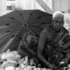 The Street Grandma with Hand of Flowers by Karthick Saravanan - Photojournalism, Street Photography, Art Photography, Photography Awards, Light & Composition University