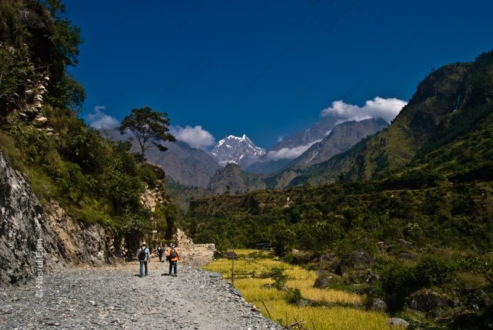 Two Figures on the Road to the Snow-Capped Mountain - Photography Composition, Visual Storytelling Photography, Landscape Photography Techniques, Documentary Photography Composition, Photo Technique Tutorials, Expert Photography Guides