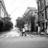 Two Men Crossing a Rain-Washed Street