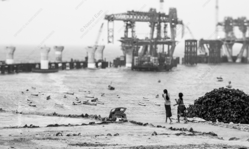 Walking against a Backdrop of Industrial Advancement - Fine Art Photography Prints, Limited Edition Photography, Museum-Quality Photography, Photography Art Collectors, Documentary Photography