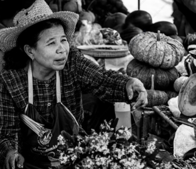 Market Vendor with Woven Hat and Pumpkins - Black and white photography, documentary photography, portrait photography, fine art photography, Nasrul