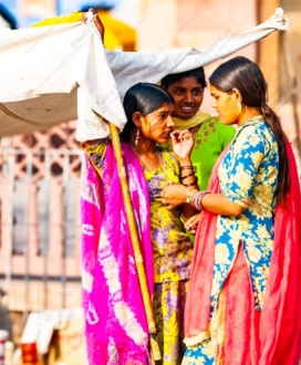 Three Women Under a Sunlit Canopy