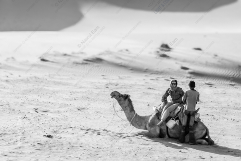 Desert Pause: Riders and Resting Camel - Fine Art Photography Prints, Limited Edition Photography, Luxury Photography Art, Museum-Quality Photography, Fine Art Prints