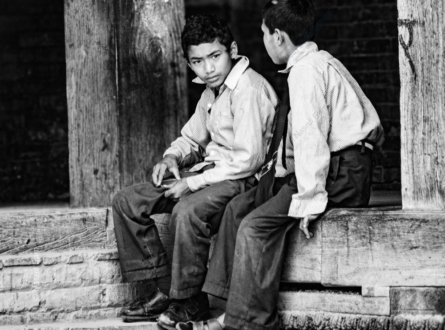 Two Boys Resting on a Timber Beam