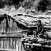 Girl Seated on a Rooftop of Stone and Wood