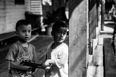 Two Boys with a Toy Rifle - Fine Art Photography Print, Limited Edition Photography, Black and White Photography, Giclée Print, Contemporary Art Photography