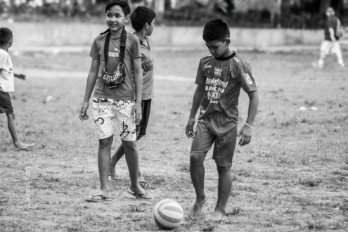 Boys with a Soccer Ball on a Worn Field - Fine Art Photography Print, Limited Edition Photography, Monochrome Photography, Childhood Photography, Art Photography for Sale