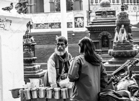 Street Vendor's Gaze Amidst Ancient Stones