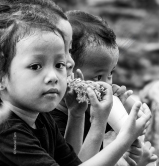 Three Young Faces, One Cracker