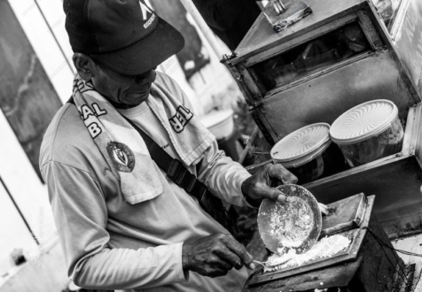 Vendor's Hands at the Griddle
