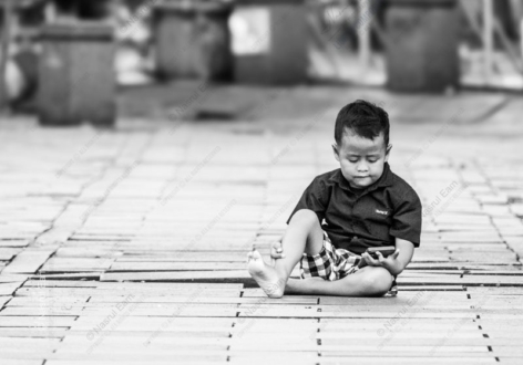 A Boy and His Phone on a Wooden Floor