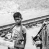 Young Vendor by the Railway Tracks - Fine Art Photography Print, Limited Edition Photography, Black and White Photography,  Art Photography for Sale, Collector Photography