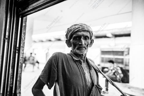 The Worker at the Threshold - Portrait photography, fine art photography, visual storytelling, contemporary portraiture, light and shadow photography, human condition photography