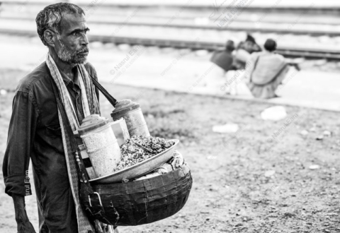Vendor by the Railway Tracks - documentary portraiture, photography technique tutorials, visual storytelling photography, human emotion in photography, street photography guide