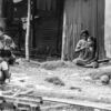 Women and Children by the Corrugated Roadside - Visual storytelling photography, documentary photography, fine art prints, human connection photography, black and white photography, contemporary photography