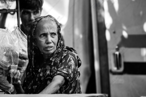 Woman Holding Bread by the Roadside - fine art photography, documentary photography, portrait photography, visual storytelling, photography techniques