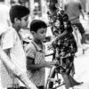 Three Boys at a Market Stall