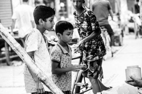 Three Boys at a Market Stall