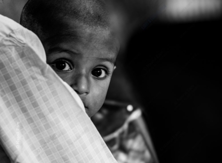 A Child's Gaze from a Protector's Shoulder