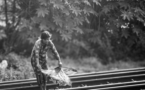 A Young Woman on the Train Tracks