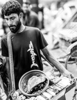 The Young Vendor's Downward Gaze